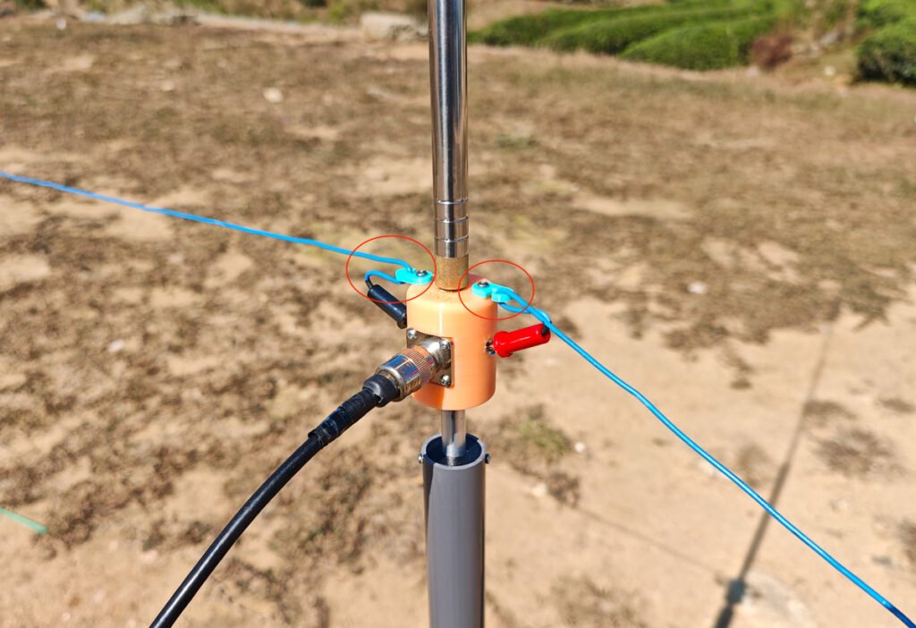 Antenna base hooks preventing banana plug from slipping out of socket