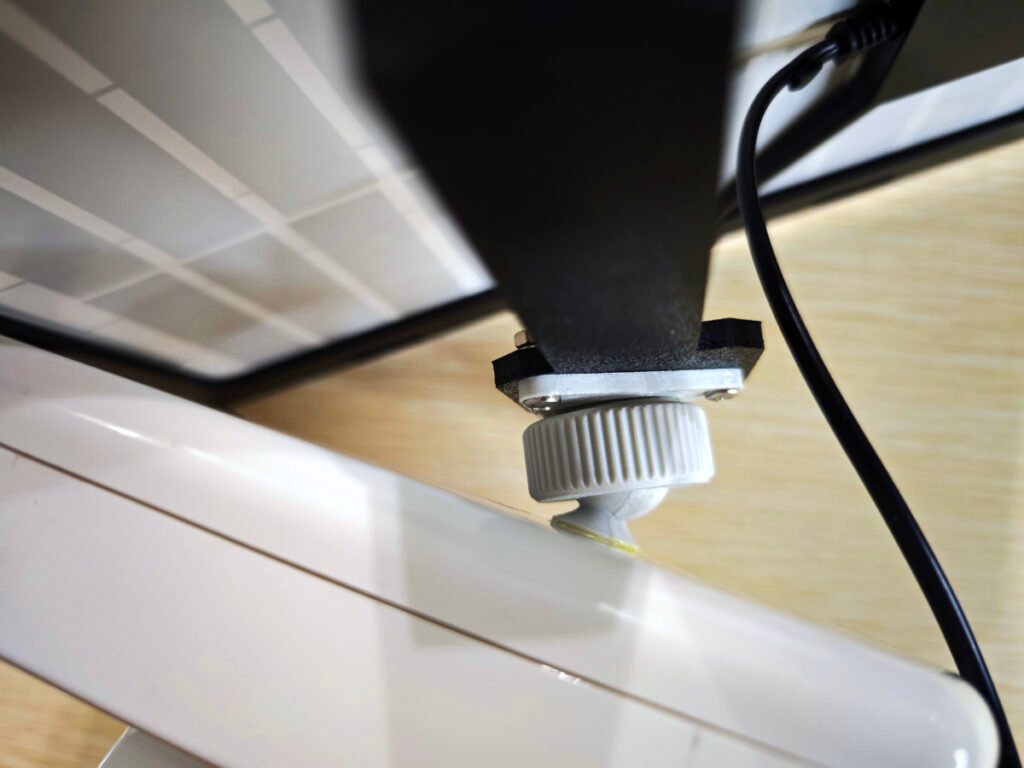 A closeup view of solar panel and ball joint installed on Meshtastic node enclosure