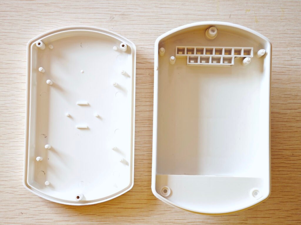 Empty weatherproof outdoor AP CPE plastic enclosure shell, open lid and base with internal mounting posts and terminal block for Meshtastic solar base station project