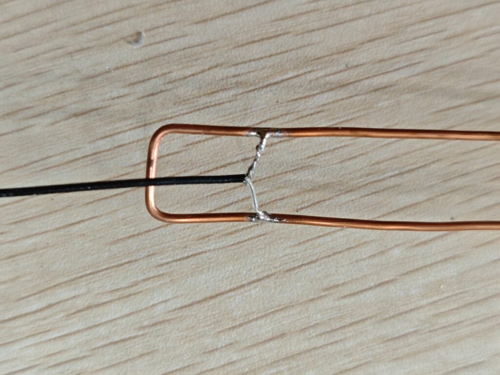Coax pigtail soldered to the feed point of a homemade J-Pole antenna