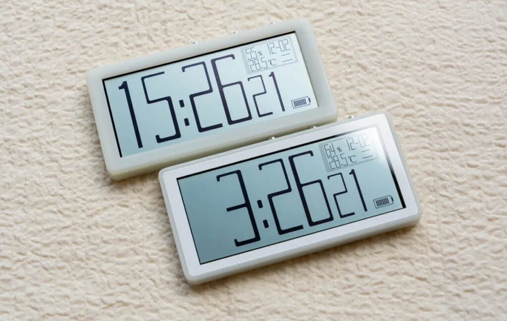 Assembled low-power music visualizer clock showing time, date, and reflective display