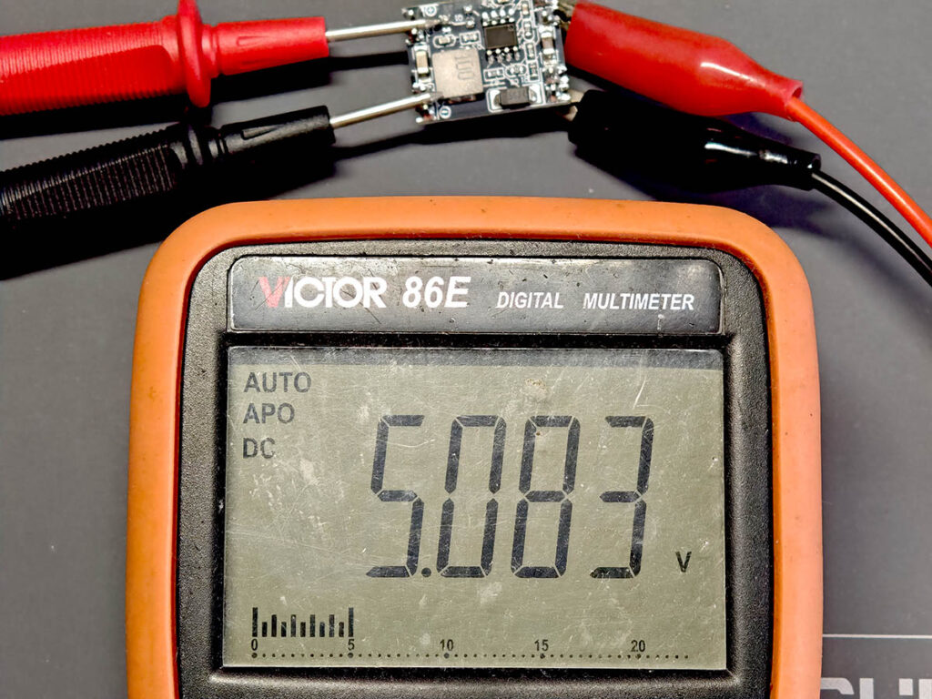 Multimeter showing PlantLab MP1584EN module output adjusted to 5V